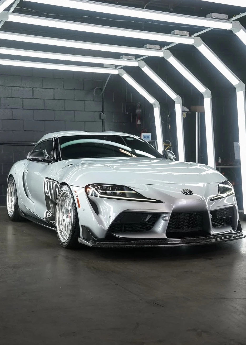 White Toyota Supra with a reflective finish in the detailing studio